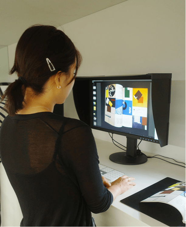 Rachel Chen at a computer, design on screen